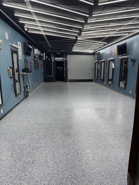 Gray flake commercial hallway floor coating in a salon with blue walls