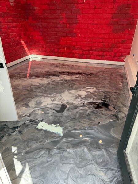Red brick accent room with gray and black metallic epoxy floor
