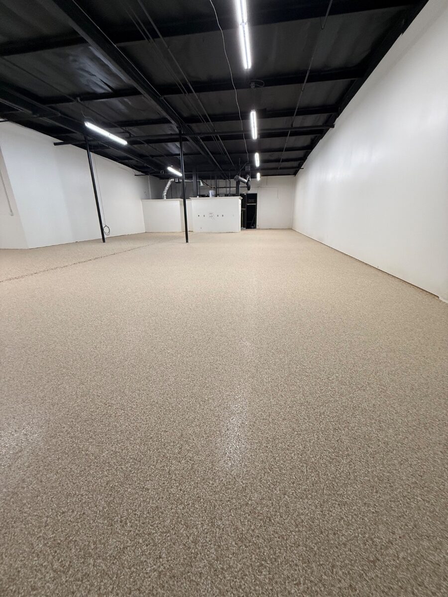 Light tan decorative flake commercial warehouse floor coating
